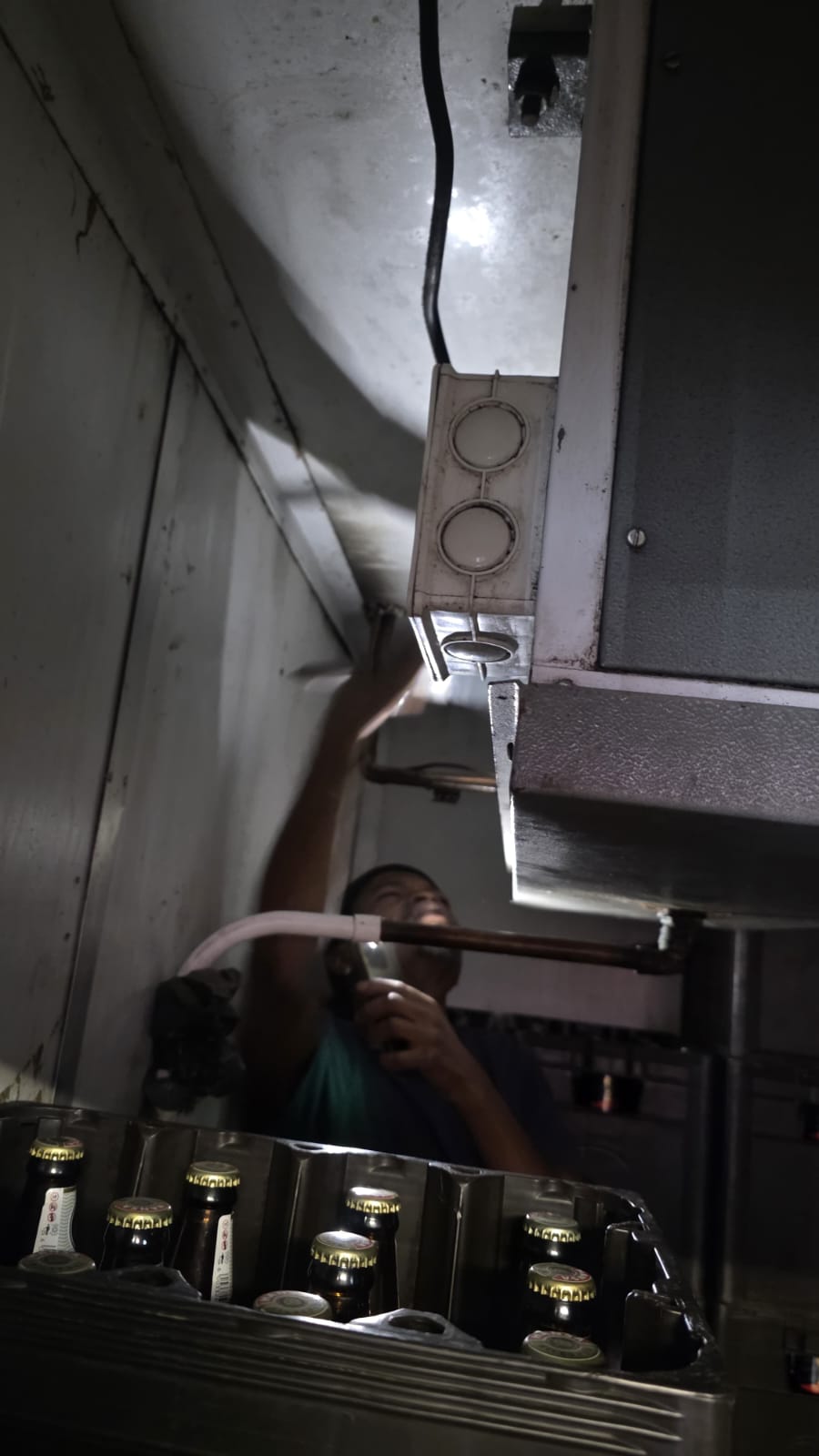 NOVA Cool technician servicing a walk-in cold room evaporator in a store