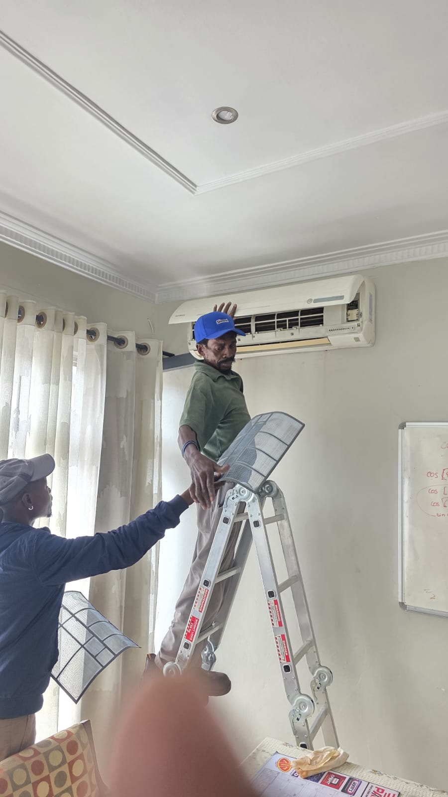 NOVA Cool technicians servicing a wall-mounted air-conditioning unit