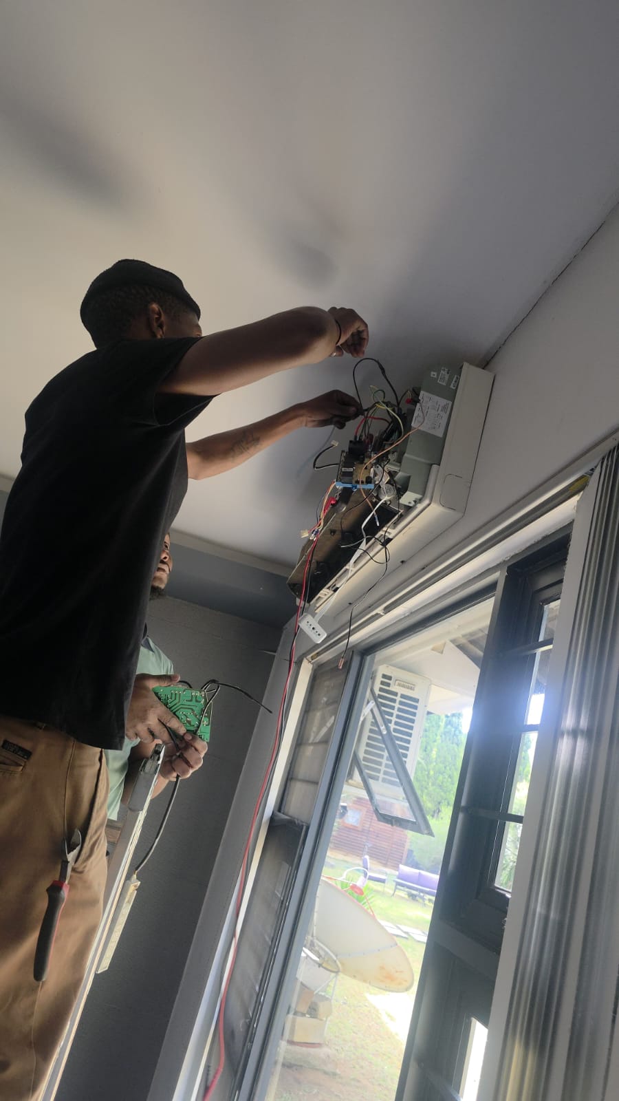 NOVA Cool technicians testing the control board of a split-system air conditioner