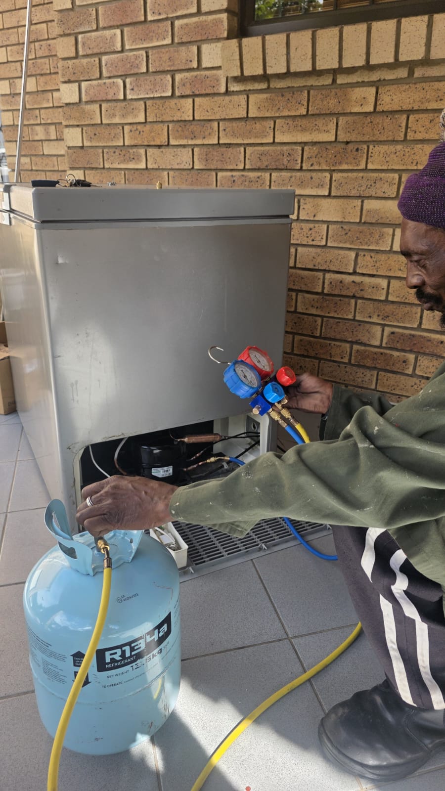 NOVA Cool technician regassing a chest freezer with R134a refrigerant